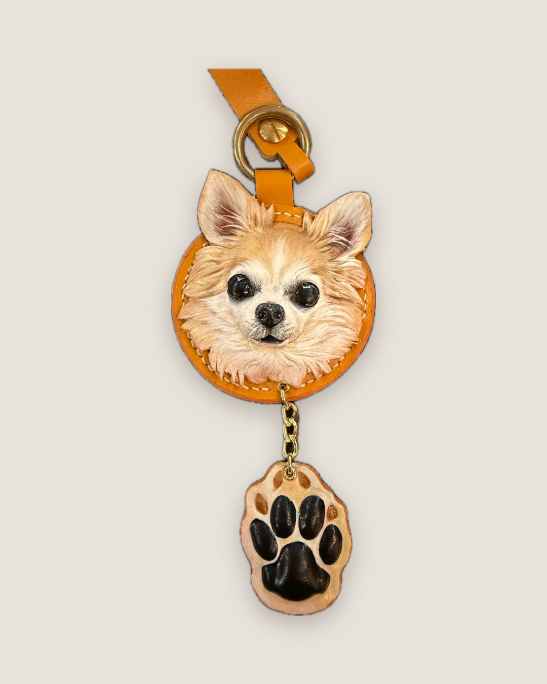 Round chihuahua keychain with a matching paw charm